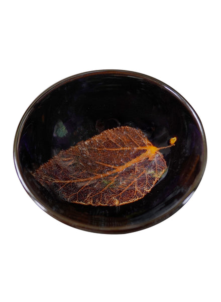 Ceramic cup with a lifelike leaf at the bottom