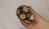 Bowl features an exquisite floral design in a contrasting black and beige color scheme