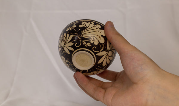 Bowl features an exquisite floral design in a contrasting black and beige color scheme